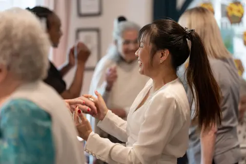carer dancing with residents at a party