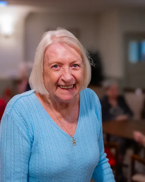 A resident in the lounge at Aria Care Home