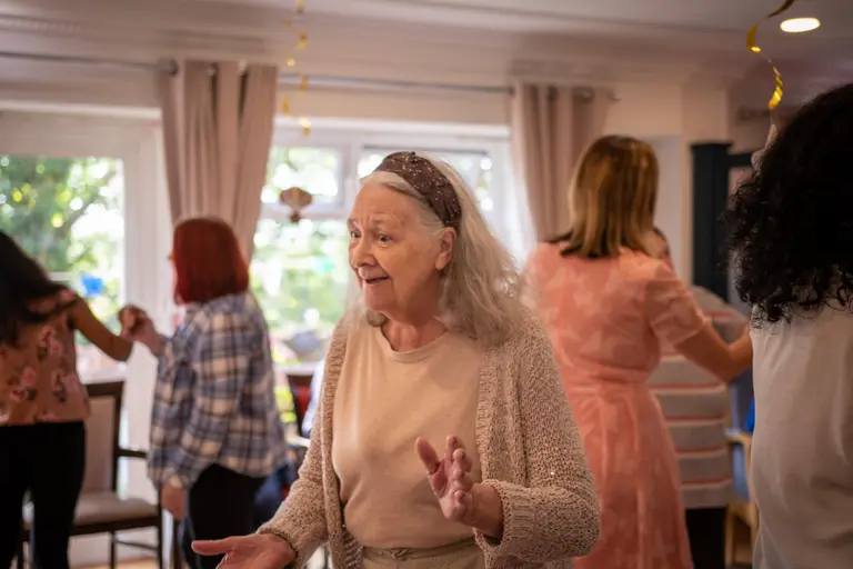 Resident smiling and dancing